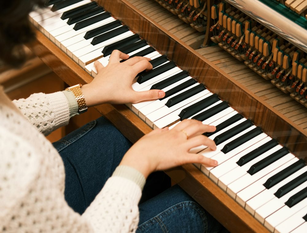 An upright piano photographed in a warm living room